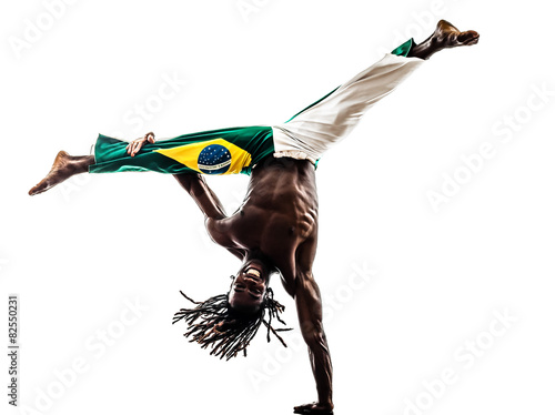 Brazilian  black man dancer dancing capoeira  silhouette photo
