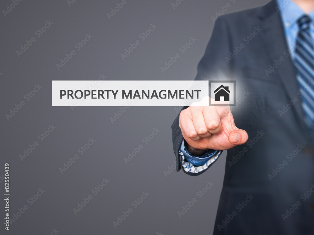 Businessman pressing property management button Businessman pressing property management button