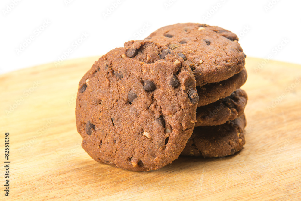 Homemade cookies with chocolate and hazelnuts on a wooden plate Homemade cookies with chocolate and hazelnuts on a wooden plate