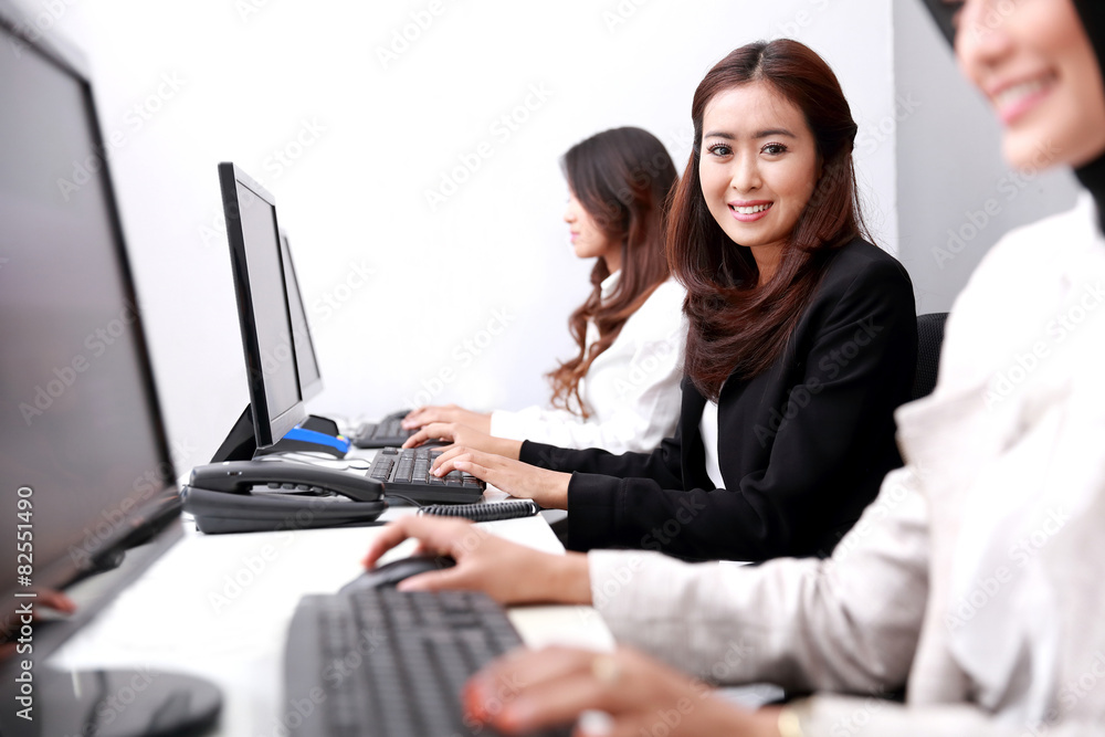 businesswoman smiling and looking at camera while working businesswoman smiling and looking at camera while working