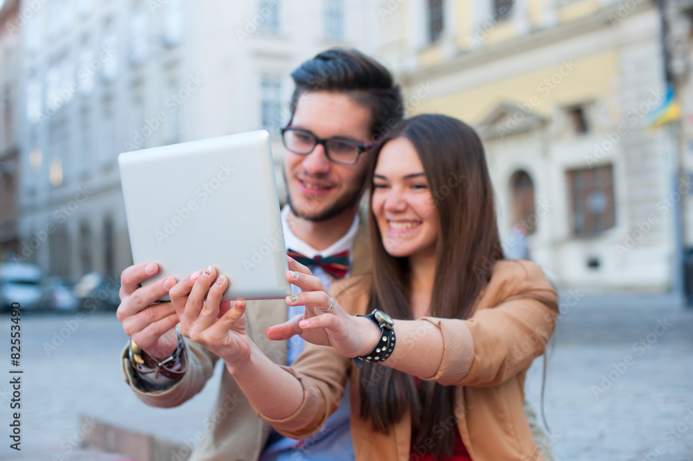 Young couple sitting on stairs in summer photographs