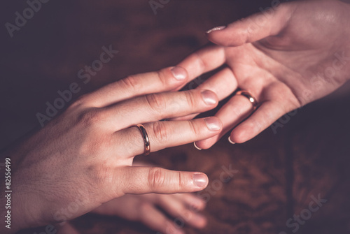 Wedding couple holding hands with rings on fingers