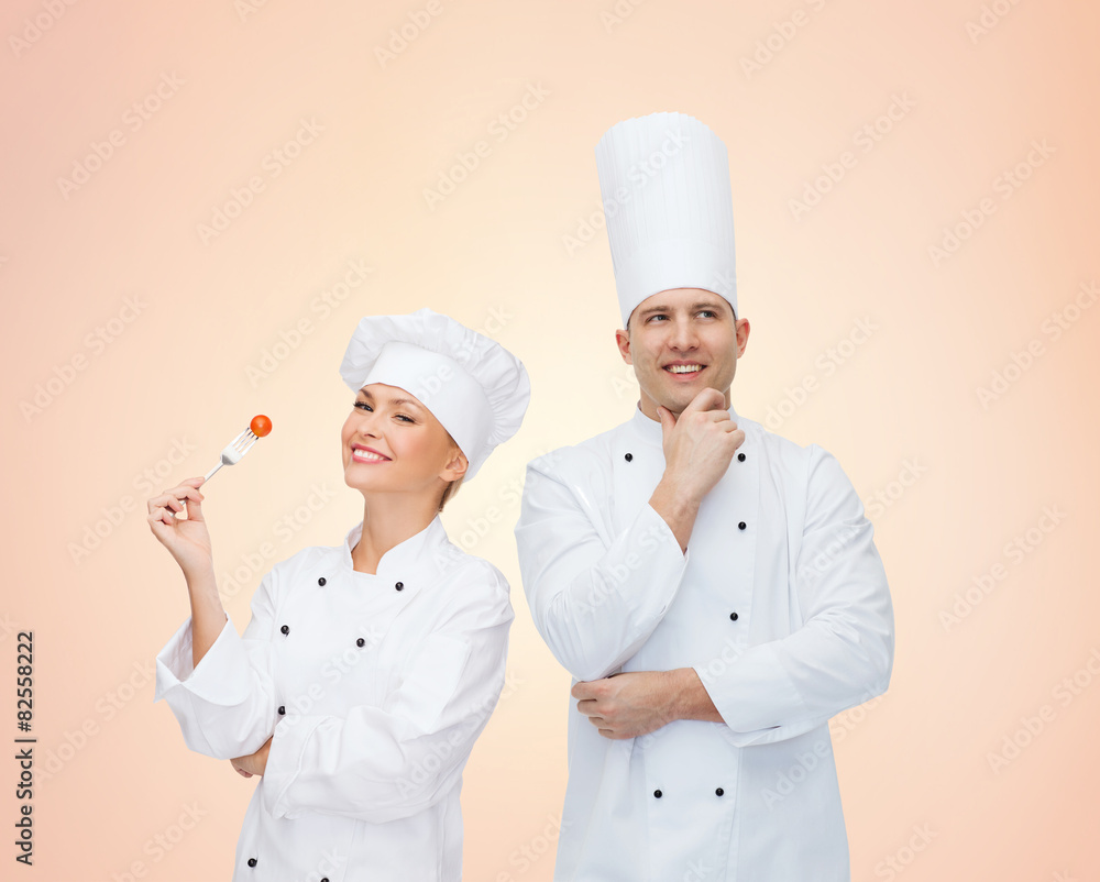 happy chefs or cooks couple over beige background happy chefs or cooks couple over beige background