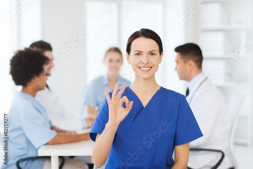 happy doctor over group of medics at hospital