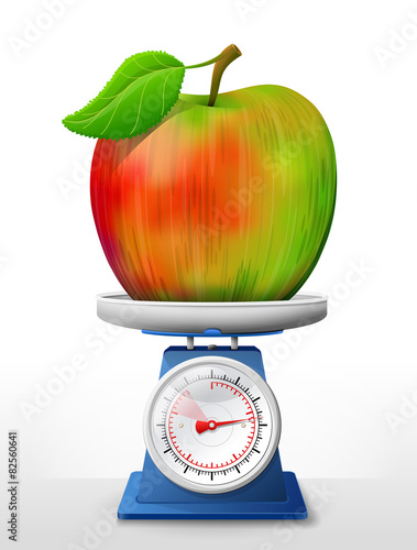 Apple fruit on scale pan. Weighing apple with leaf on scales