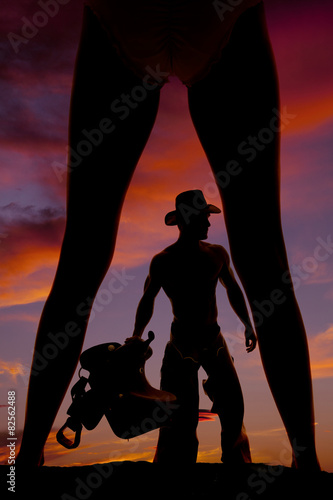 silhouette of a woman in a bikini legs out cowboy with saddle