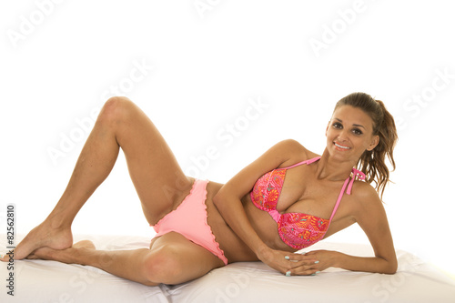 woman in pink bikini lay on side knee up