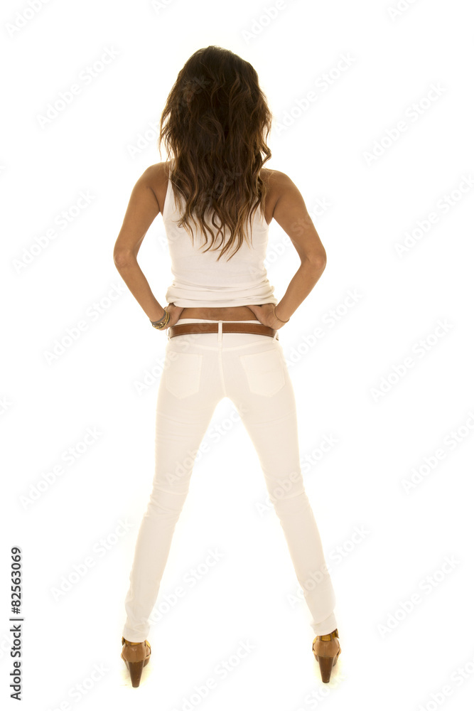 woman with dark skin and white clothes stand back