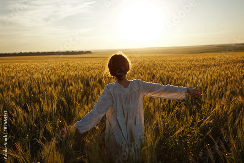 Woman in a field of ripe wheat