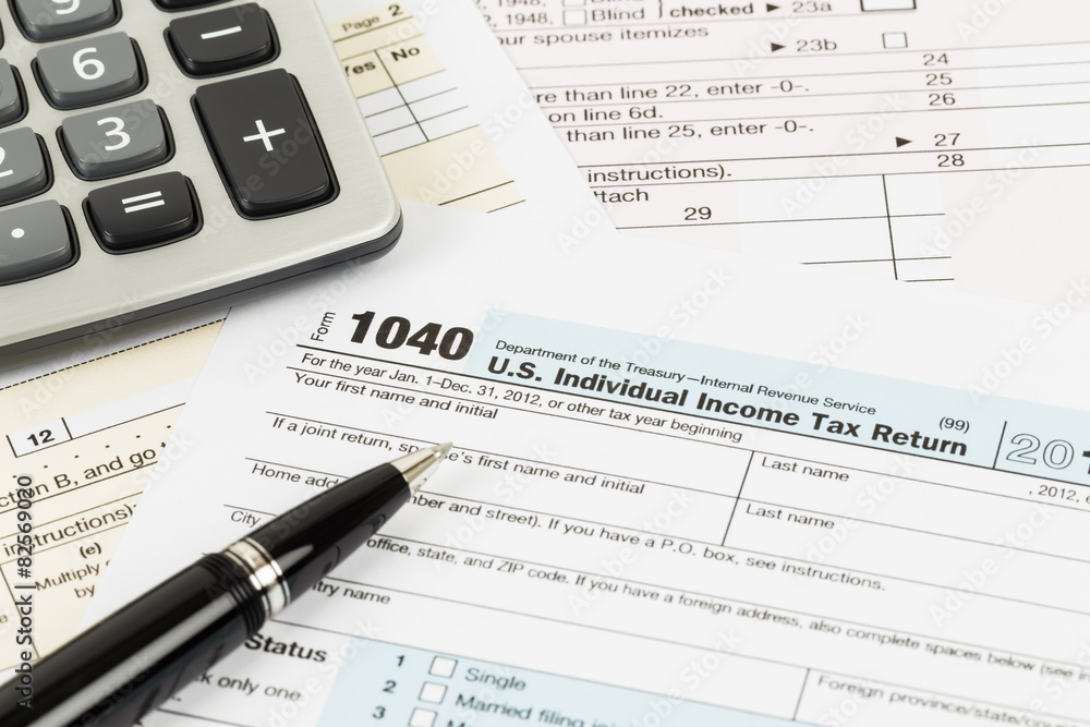 Tax form with pen and calculator Tax form with pen and calculator