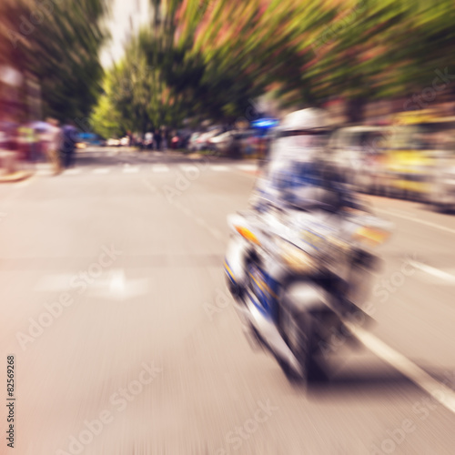 Police motorcycle racing on the street, defoced
