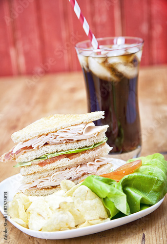 Turkey Club Sandwich with chips and soda
