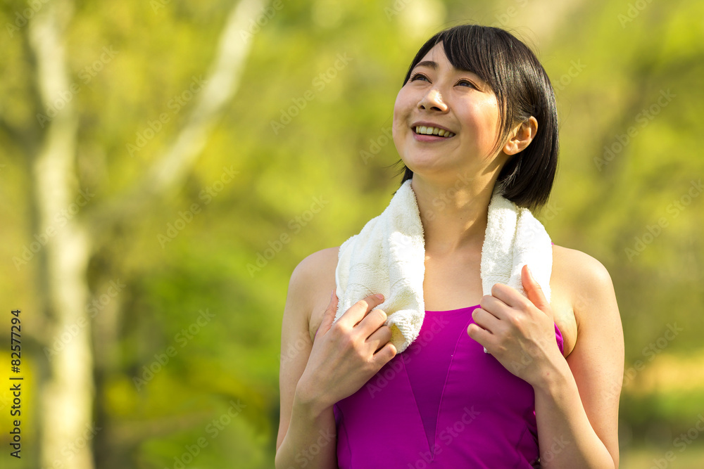Young Asian woman fitness in a park smile face portrait