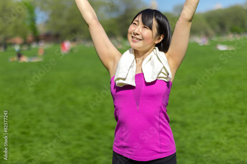 Young Asian woman fitness in a park smile happy face © blvdone