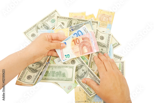 Hand over a pile of money isolated on white background