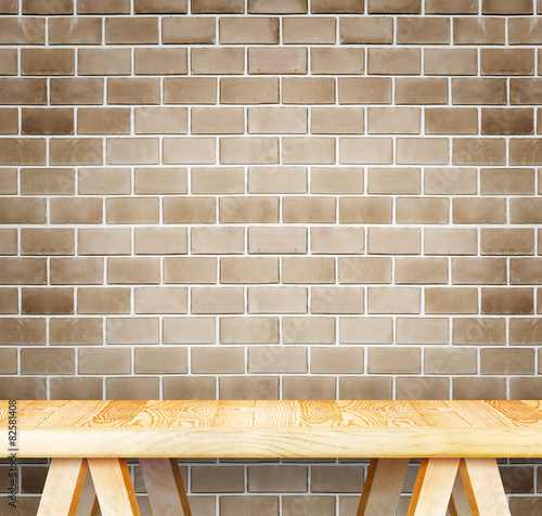 Empty wood modern table and grunge brown brick wall in backgroun