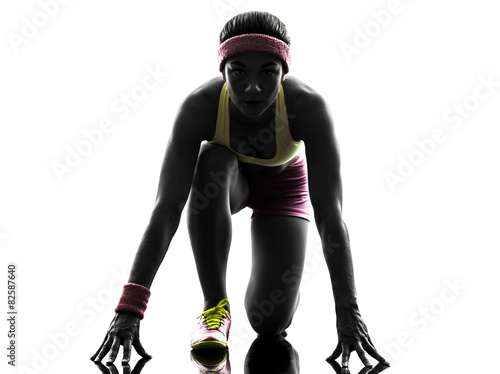 woman runner running on starting blocks silhouette © snaptitude