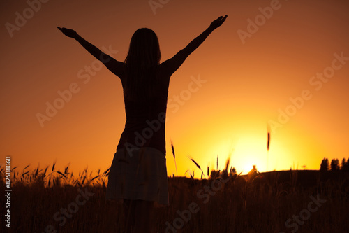 Silhouette of woman enjoying sunset © djoronimo