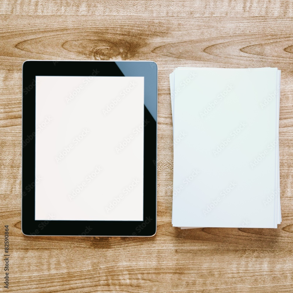 tablet and pile of blank papers on wooden background tablet and pile of blank papers on wooden background