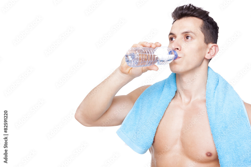 Fitness man drinking a bottle of water, isolated on white backgr Fitness man drinking a bottle of water, isolated on white backgr