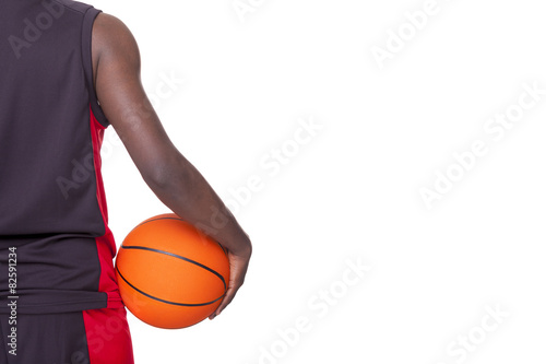 Back view of a basketball player holding a ball, isolated on whi