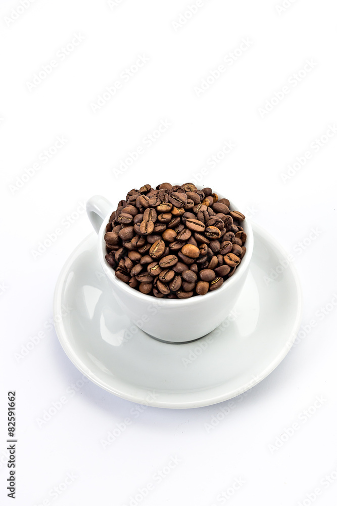 White coffee cup with saucer, and coffee-beans isolated on white