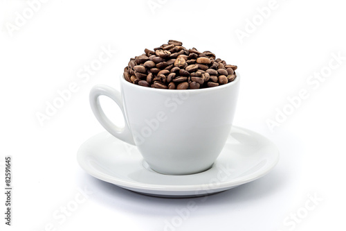 White coffee cup with saucer  and coffee-beans isolated on white