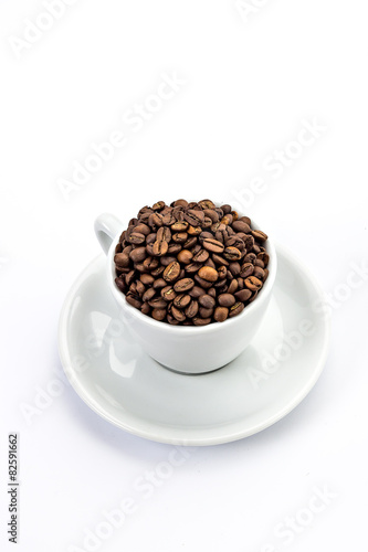 White coffee cup with saucer  and coffee-beans isolated on white