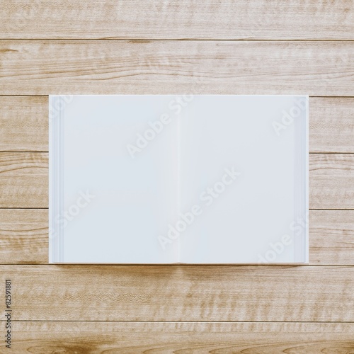  Book with blank papers on wooden textured background.