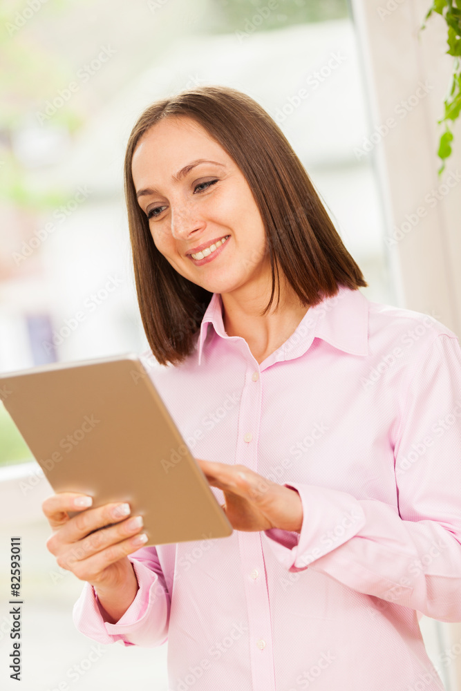 Caucasian smiling woman with a tablet pc Caucasian smiling woman with a tablet pc