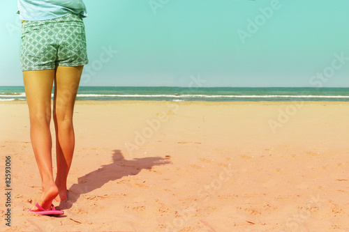 single female walking on beach close up vintage effect