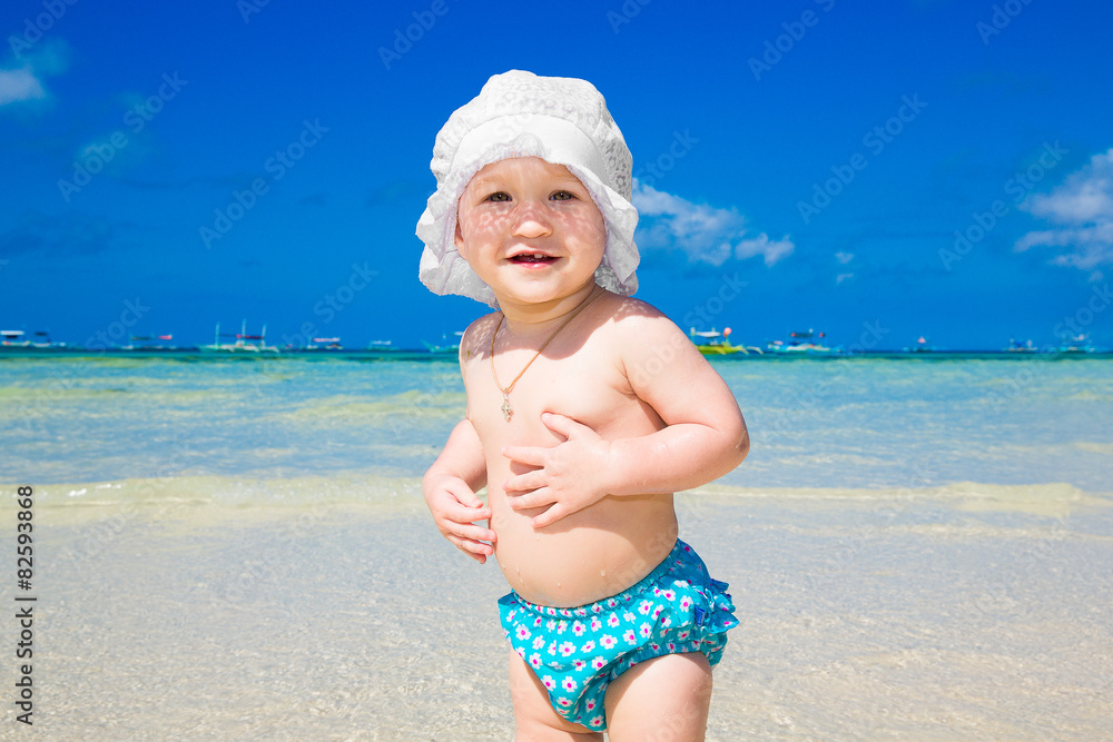 A little kid having fun on a tropical beach.