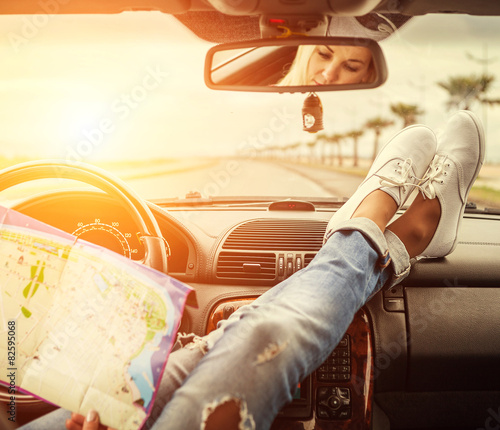 Young woman alone car traveler with map