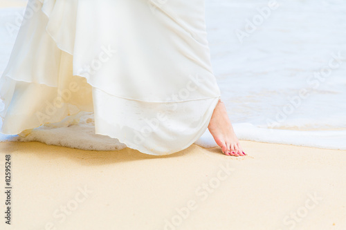 beautiful young bride in a white wedding dress walking 