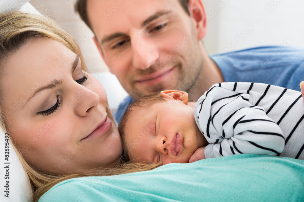 Two Parents Looking At Baby Two Parents Looking At Baby