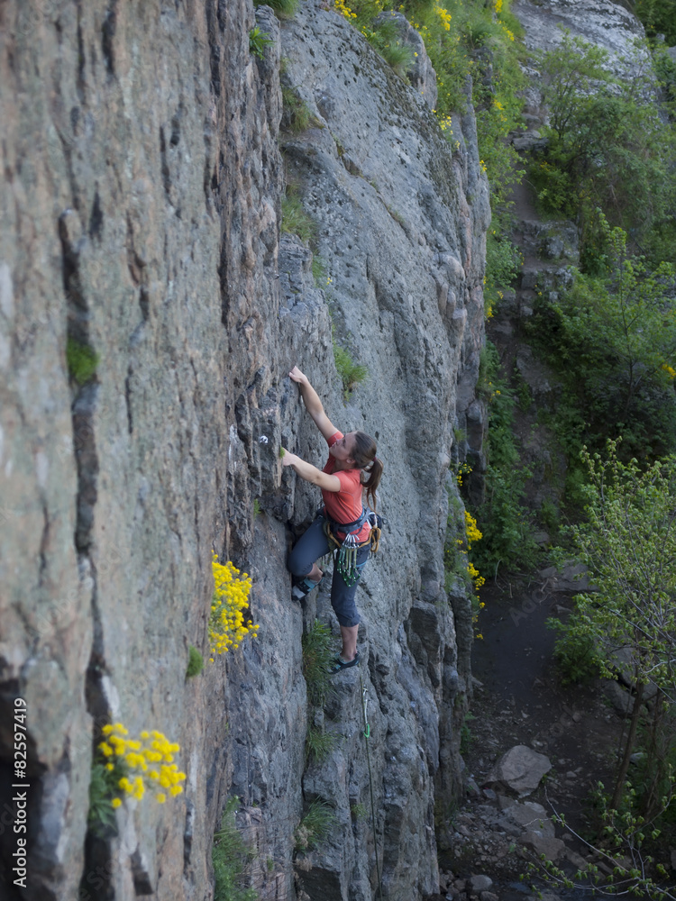A young girl engaged in rock climbing. A young girl engaged in rock climbing.