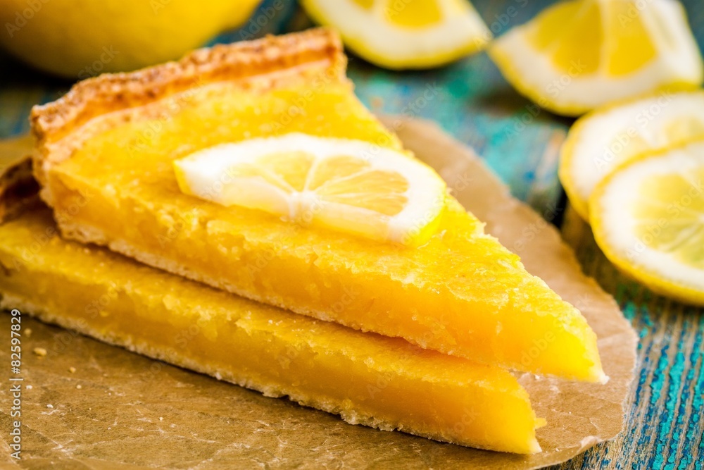 two pieces of lemon tart with slice of lemons closeup two pieces of lemon tart with slice of lemons closeup