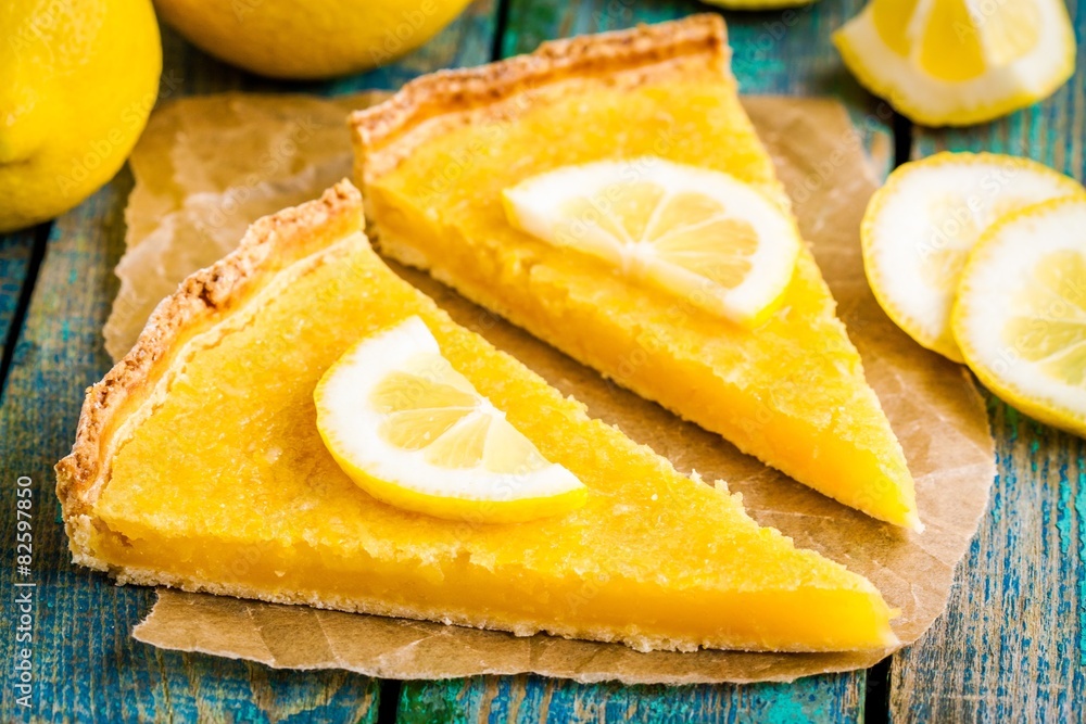 two pieces of lemon tart with slice of lemons closeup two pieces of lemon tart with slice of lemons closeup