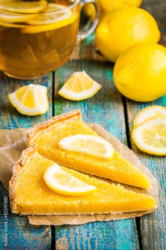 two pieces of lemon tart with slice of lemons