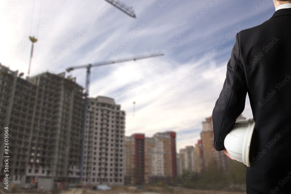Close up of engineer hand holding white safety helmet for worker Close up of engineer hand holding white safety helmet for worker