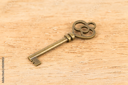 Antique key on wooden background © wirojsid
