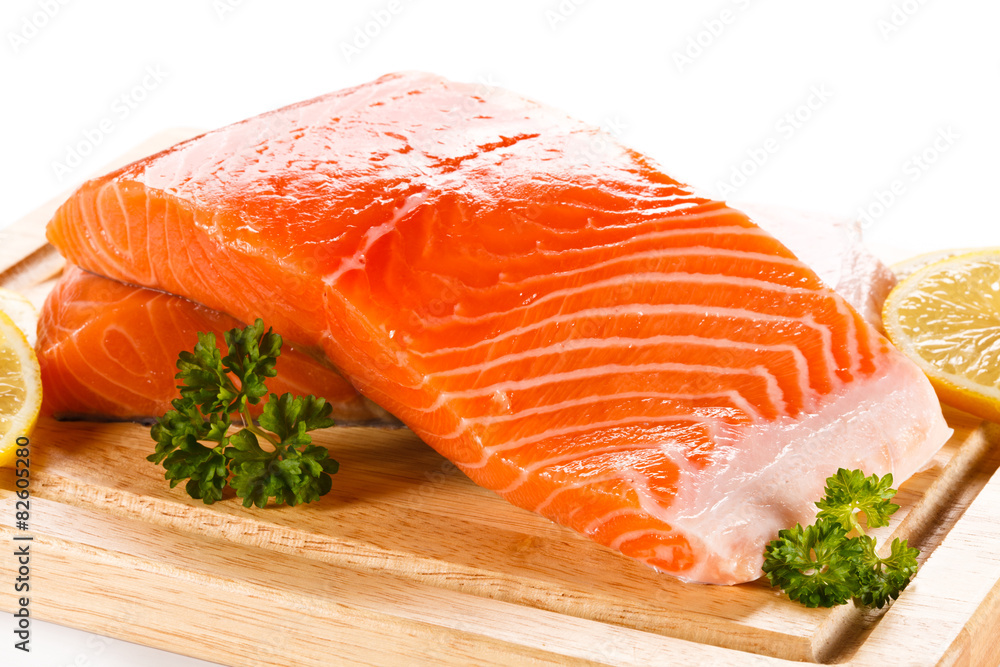 Fresh raw salmon fillet on cutting board Fresh raw salmon fillet on cutting board