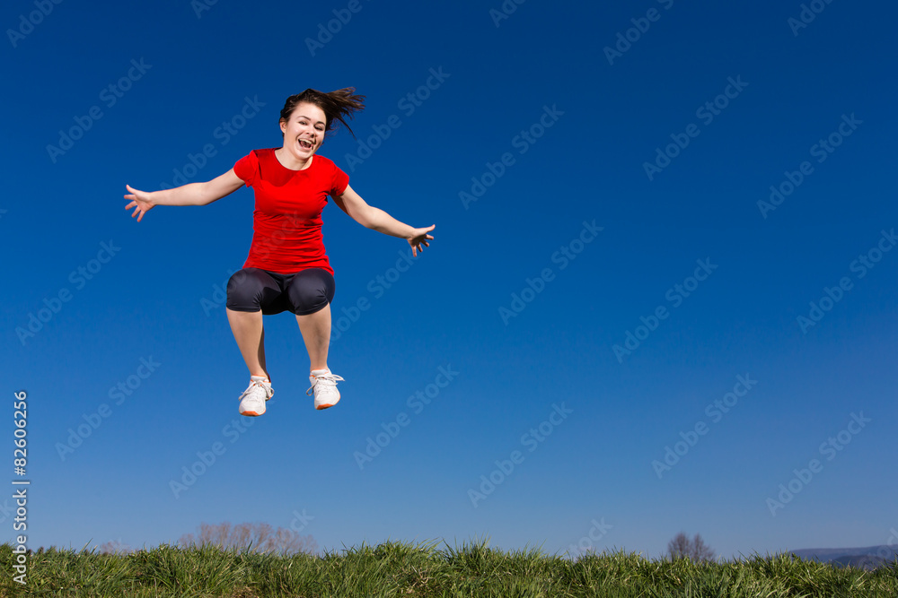 Teenage girl jumping, running outdoor against blue sky Teenage girl jumping, running outdoor against blue sky