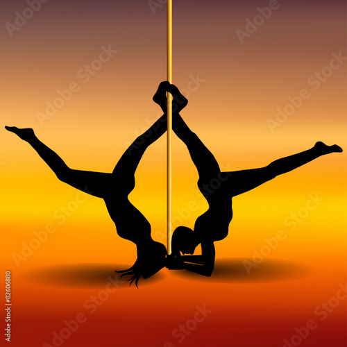 Two Pole dancers with long and short hair  on the pole  on the y