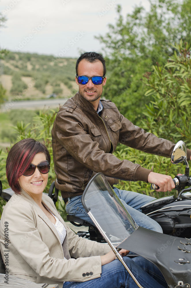 Couple posing in sidecar custom bike