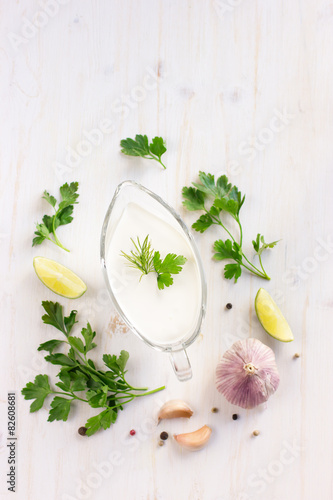 creamy sauce on glass sauceboat and ingredients