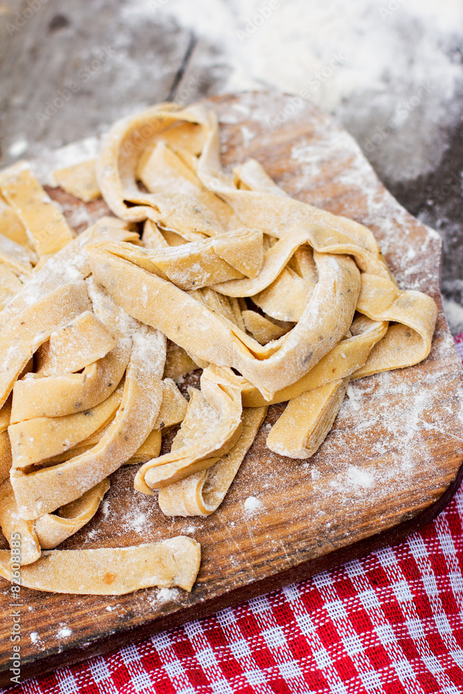 Homemade spaghetti, pasta or noodles on wooden table. Homemade spaghetti, pasta or noodles on wooden table.