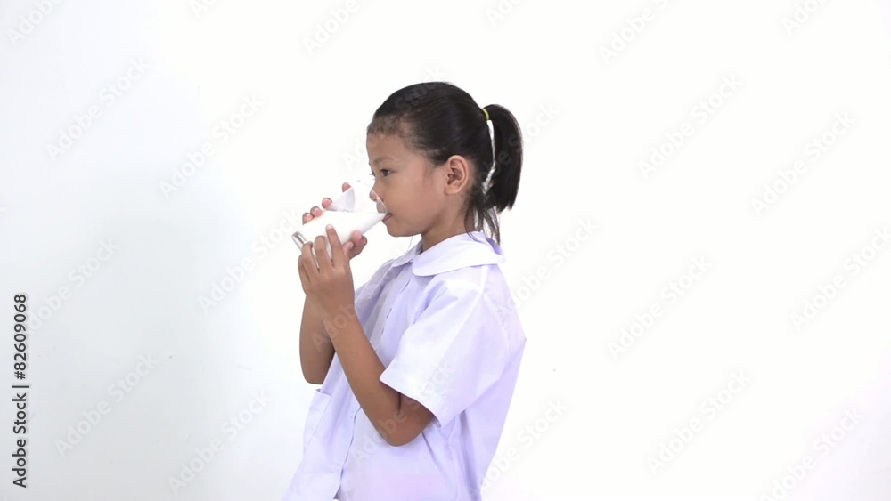 Asian Thai kids drinking milk on white background Asian Thai kids drinking milk on white background