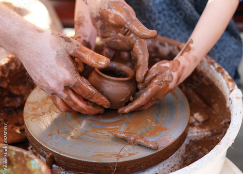 Hands working on pottery wheel