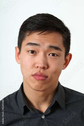 Romantic young Asian man looking at camera